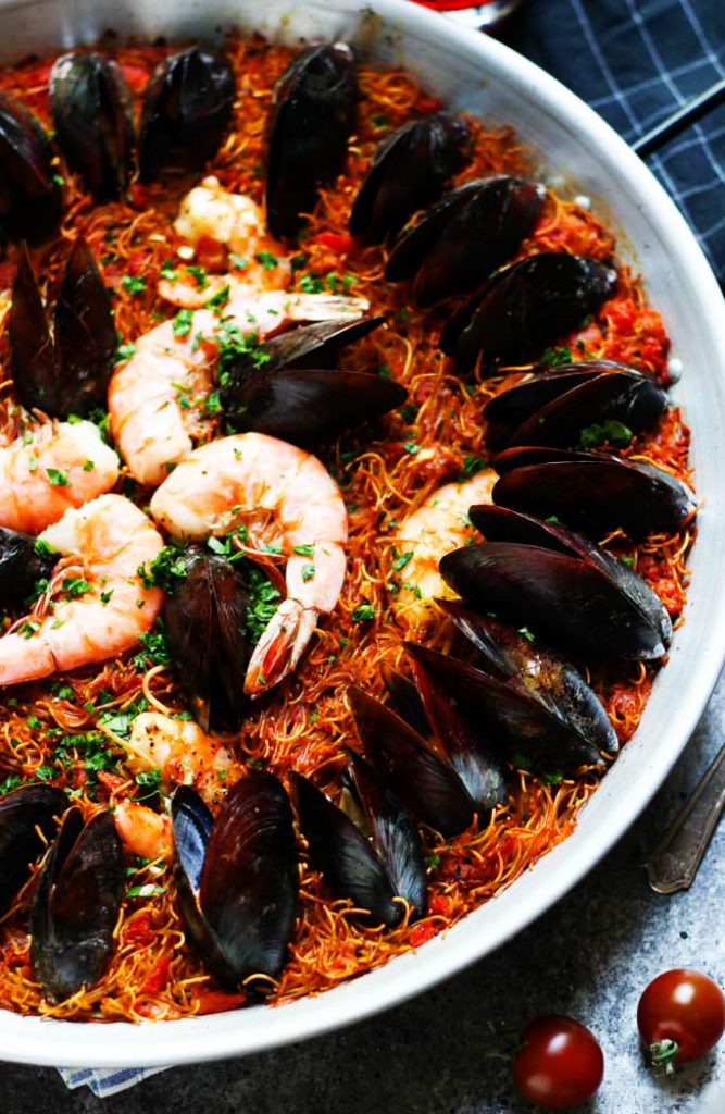 Fideuá (or broken pasta paella) is a Catalan seafood specialty and is perfect for your next party! | platingsandpairings.com