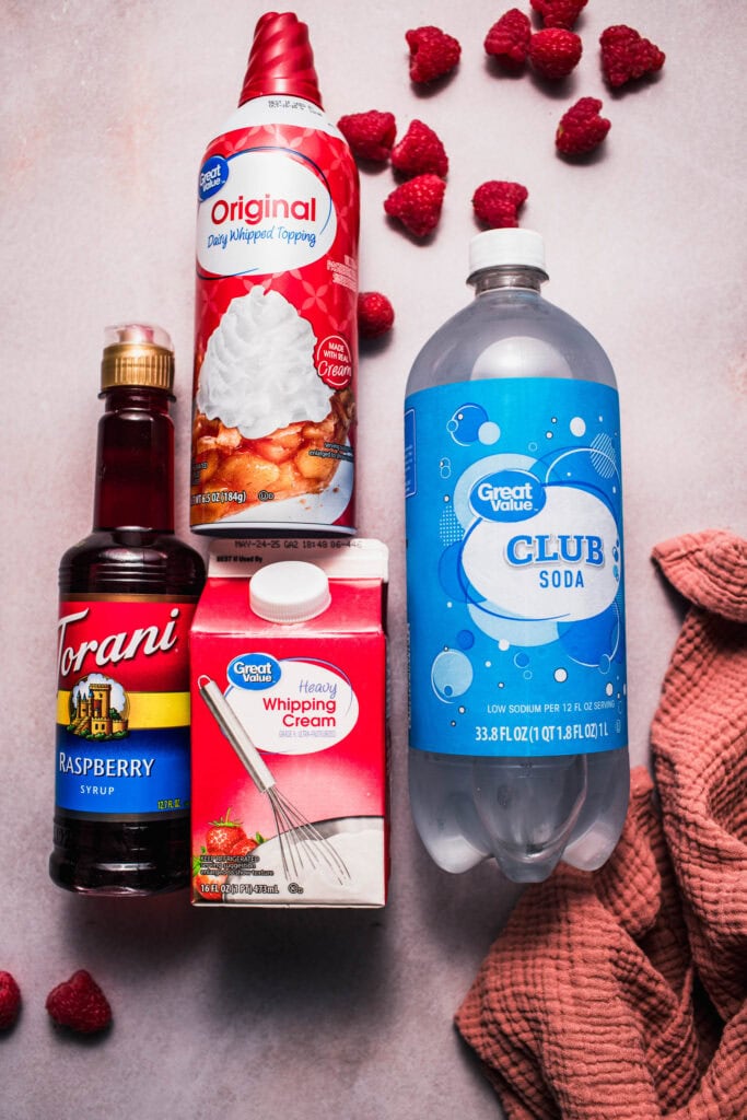 Ingredients for raspberry italian sodas on counter. 