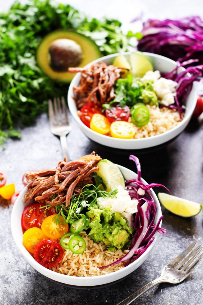 These Slow Cooker Steak Carnitas Bowls are super simple to make with the help of your crockpot. Finish them off with a quick guacamole and a combination of your favorite toppings for a healthy weeknight dinner | platingsandpairings.com
