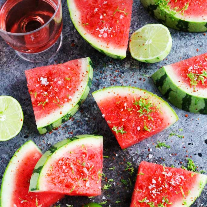 Sprinkle watermelon with Aleppo chili pepper, lime zest, and salt for an icy-cold sweet and spicy treat that's perfect for summer | platingsandpairings.com