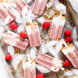 These Yogurt & Granola Breakfast Protein Popsicles prove that you can have dessert for breakfast! Made with raspberries, dairy-free yogurt, and hearty granola - It's a healthy vegan treat that will keep you energized throughout the morning. | platingsandpairings.com