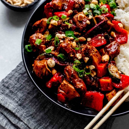 Side view of plate of kung pao chicken.