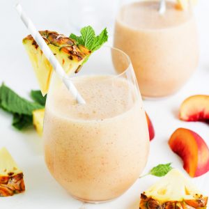 This Pineapple Peach Mint Smoothie is a refreshing way to start your day! Pineapple, peach and pear combine with fresh mint in this tasty treat. The addition of acai berry powder and pumpkin seeds gives a nutritional boost. | platingsandpairings.com