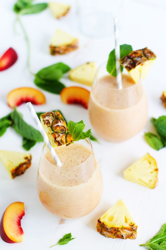 This Pineapple Peach Mint Smoothie is a refreshing way to start your day! Pineapple, peach and pear combine with fresh mint in this tasty treat. The addition of acai berry powder and pumpkin seeds gives a nutritional boost. | platingsandpairings.com