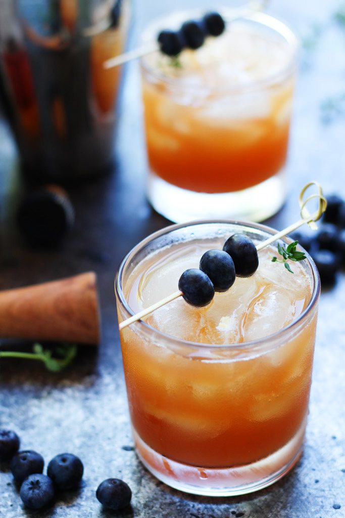 This Blueberry Bourbon Smash Cocktail combines fresh blueberries, apple cider, vanilla and bourbon for a comforting cocktail that's perfect for the Fall season. | platingsandpairings.com