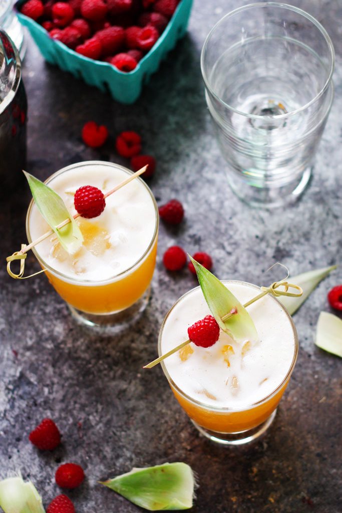 This Pineapple Raspberry Vanilla Vodka Collins is a refreshing, tropical cocktail that’s as delicious as it is beautiful. | platingsandpairings.com