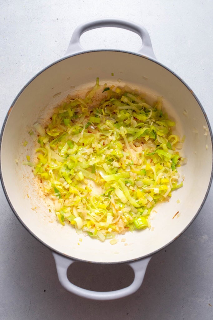 Leeks and shallot sauteed in pot.