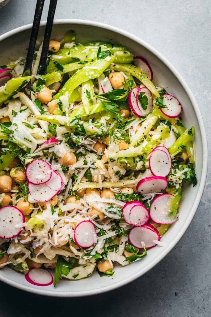 Fennel salad with chickpeas in white bowl. 