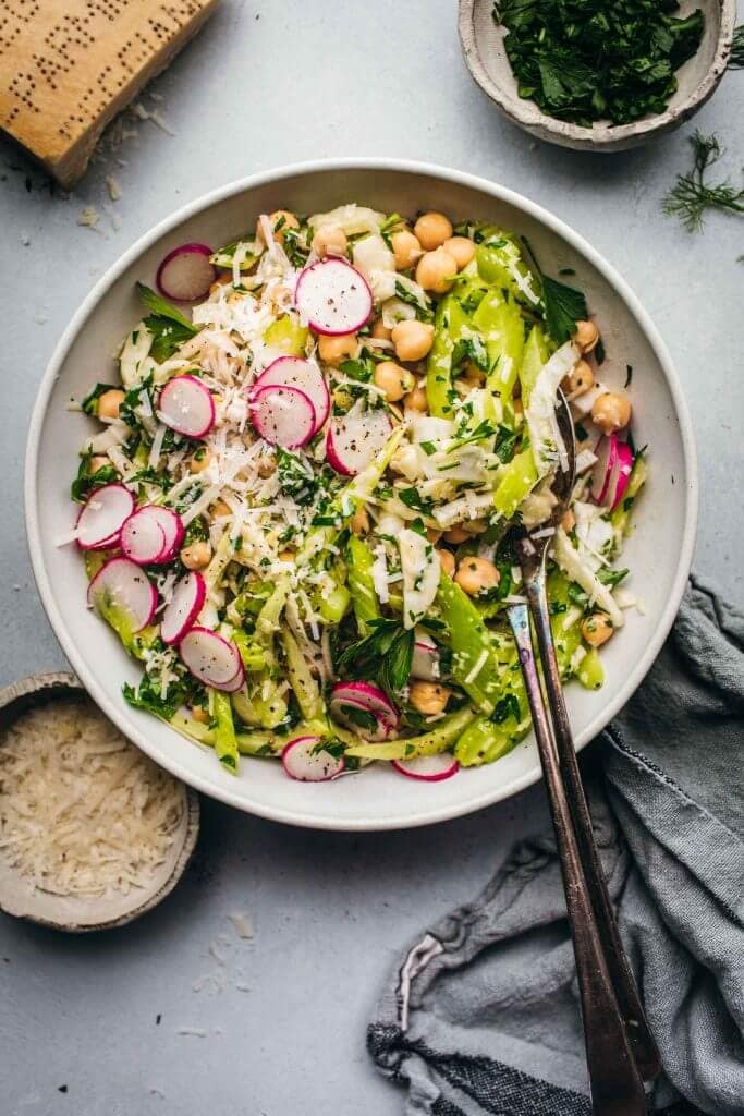 Fennel salad with chickpeas in white bowl. 