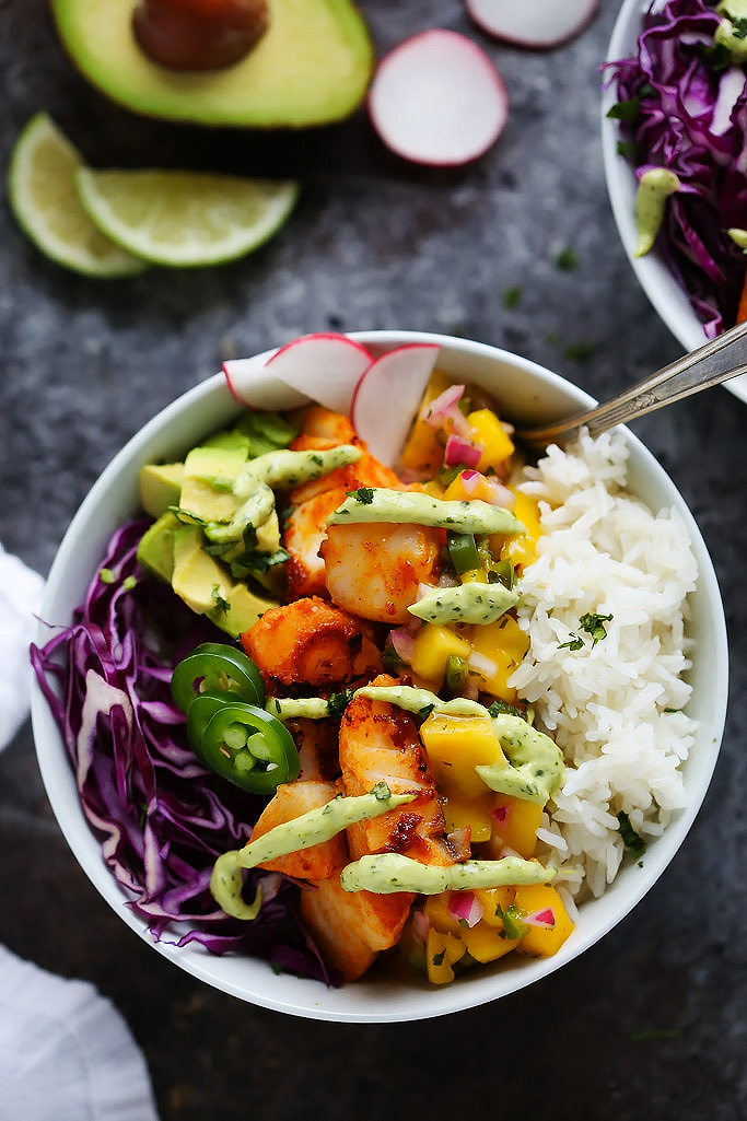 These Fish Taco Bowls with Mango Salsa & Avocado Cream Sauce make a quick and healthy weeknight dinner that's ready in under 30-minutes! | platingsandpairings.com