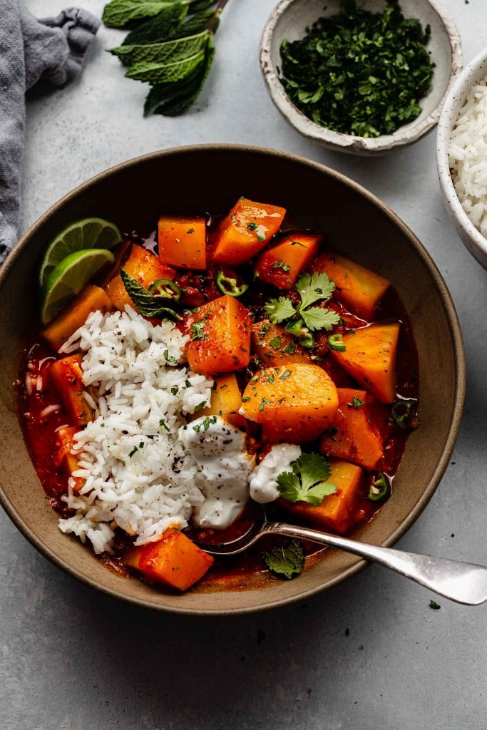 Overhead shot of aloo vindaloo in bowl with rice.