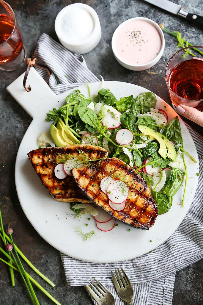 Grilled Swordfish with Tangy Rosé Wine Mayonnaise will take your grilling to the next level. Grilled swordfish is topped with rosé wine mayonnaise that is also turned into a creamy vinaigrette used to dress a simple & refreshing salad of fennel, radish and avocado. | platingsandpairings.com