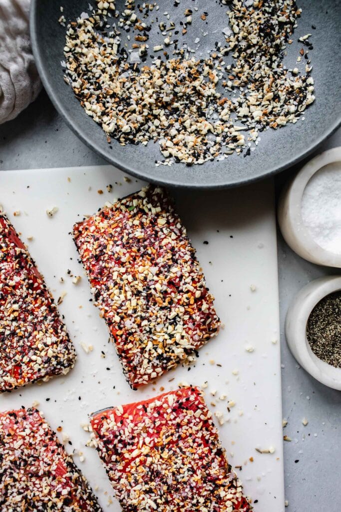 Salmon filets coated in everything bagel seasoning before cooking. 