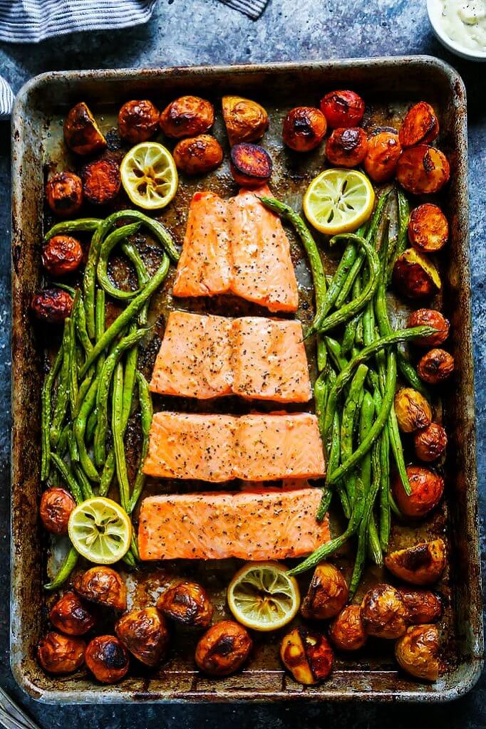 This 5 Ingredient Sheet Pan Salmon is the perfect dinner for busy weeknights! This complete seafood dinner cooks in just 30 minutes and the cleanup is easy too! | platingsandpairings.com