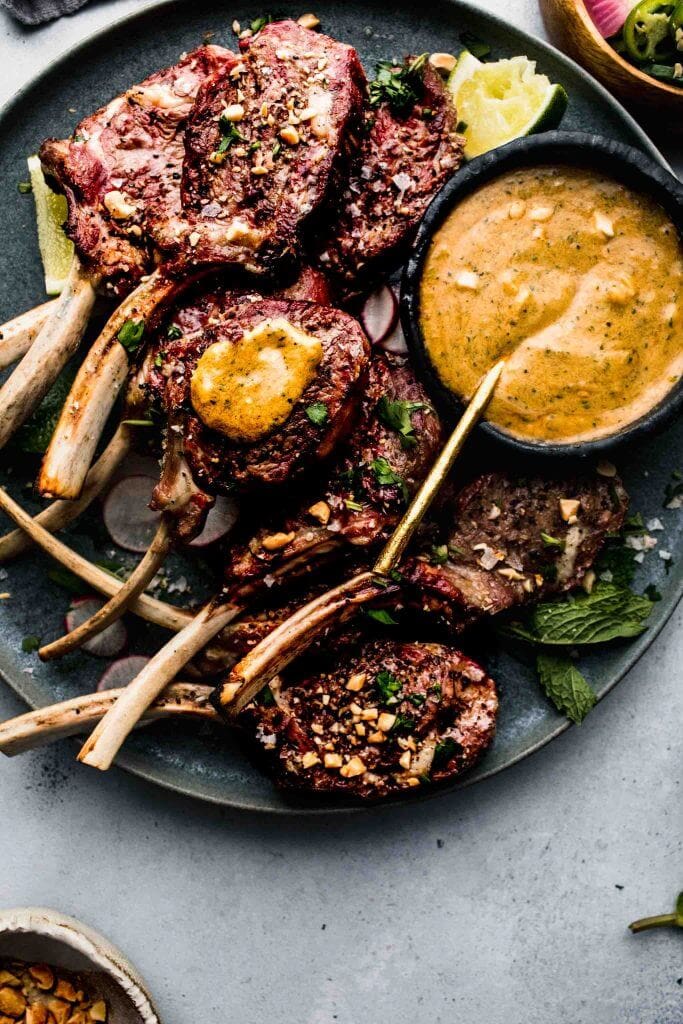 Lamb chops on plate with sauce. 