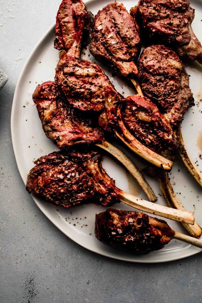 Grilled lamb chops on white plate. 
