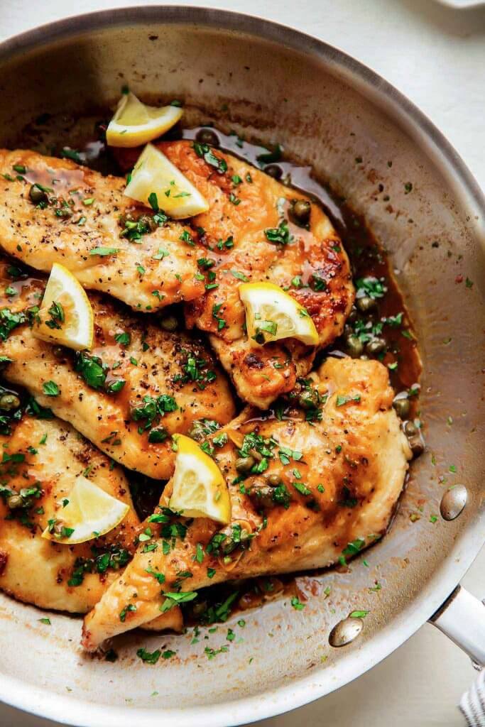 Chicken piccata in skillet.