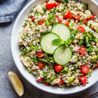 This Israeli Couscous Tabbouleh Salad recipe combines pearl couscous with tomatoes, cucumber, fresh herbs and a light citrus dressing. It's a perfect make-ahead salad recipe! | platingsandpairings.com