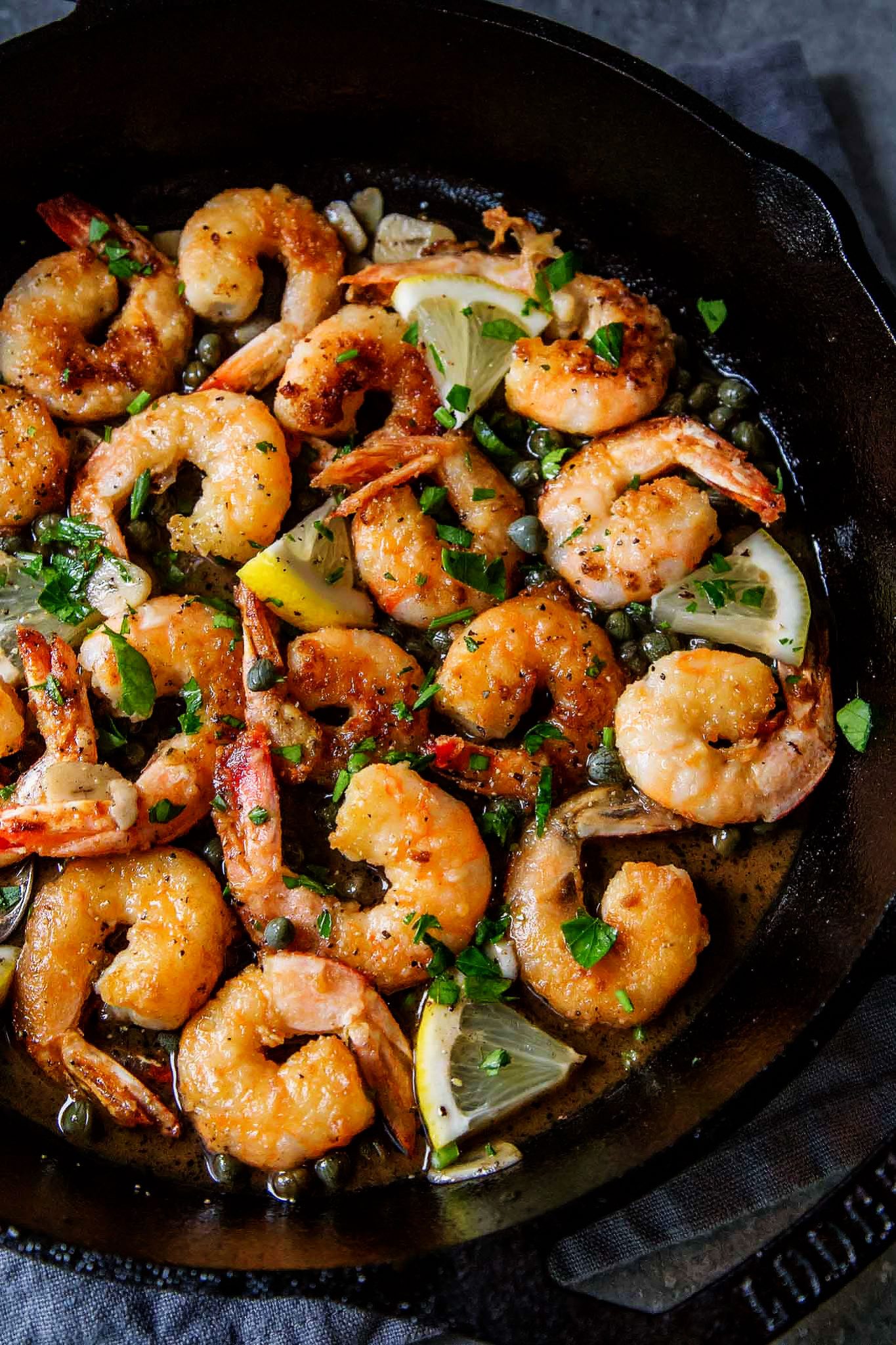 30-Minute Easy Shrimp Piccata makes a delicious appetizer, or serve the piccata over pasta for dinner. Shrimp are tossed in a lemon, garlic, butter sauce flecked with capers.