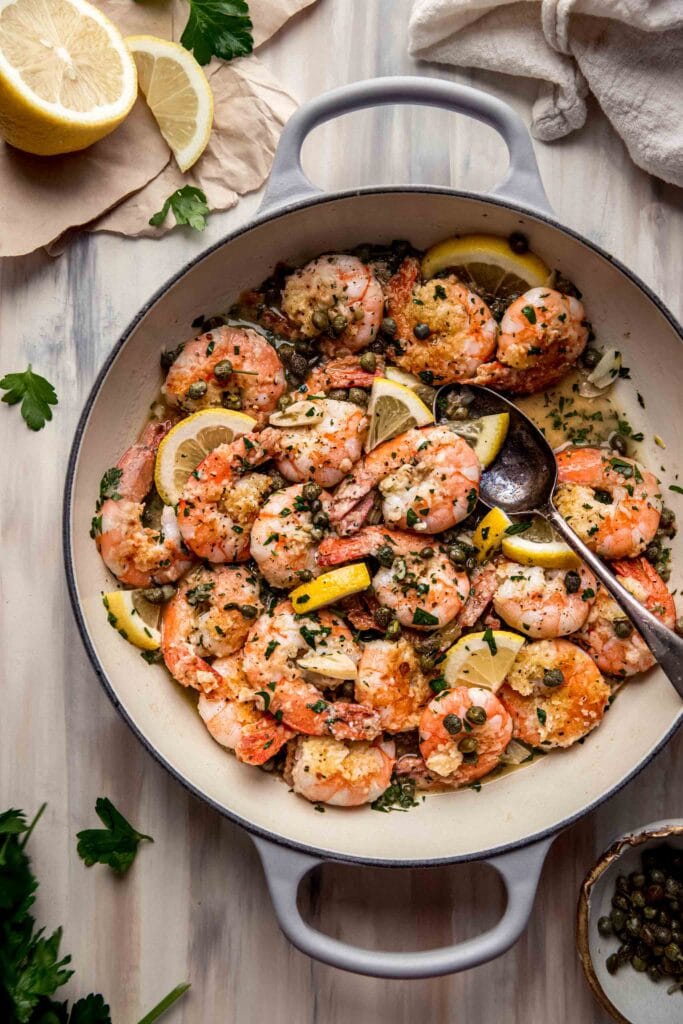 Skillet filled with shrimp piccata.