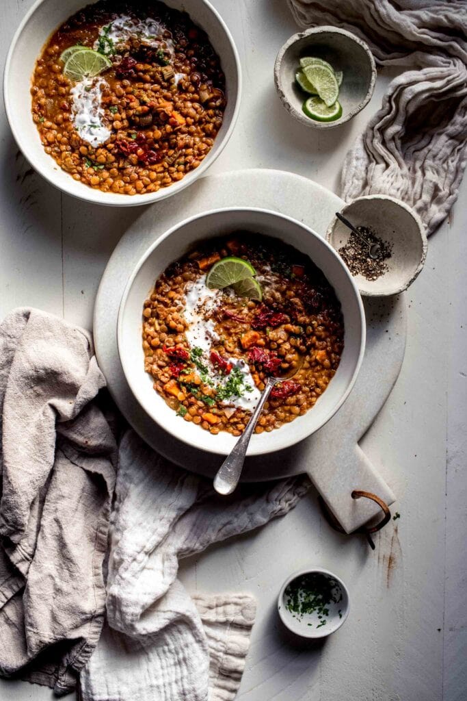 Overhead shot of two bowl of spicy lentil soup.