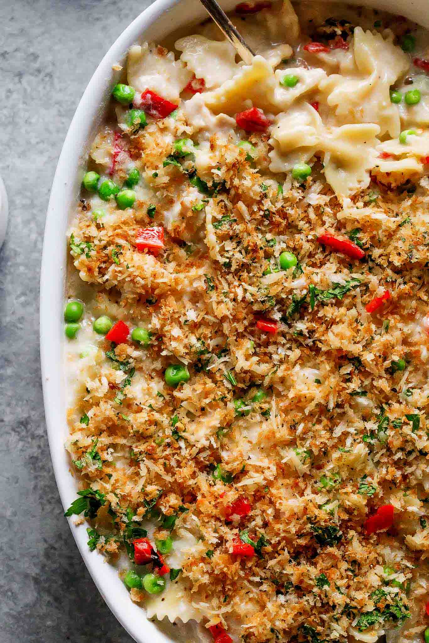 Tuna Noodle Casserole with Piquillo Peppers and Gruyere Cheese is an upgraded version of the classic tuna noodle casserole. Spiked with a bit of white wine and topped with buttery parmesan breadcrumbs – Yum! | platingsandpairings.com