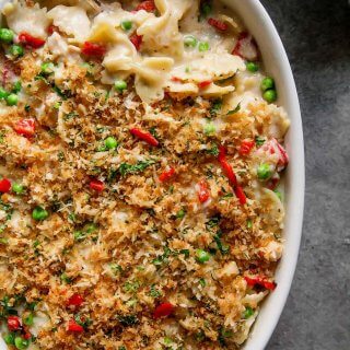 Tuna Noodle Casserole with Piquillo Peppers and Gruyere Cheese is an upgraded version of the classic tuna noodle casserole. Spiked with a bit of white wine and topped with buttery parmesan breadcrumbs – Yum! | platingsandpairings.com