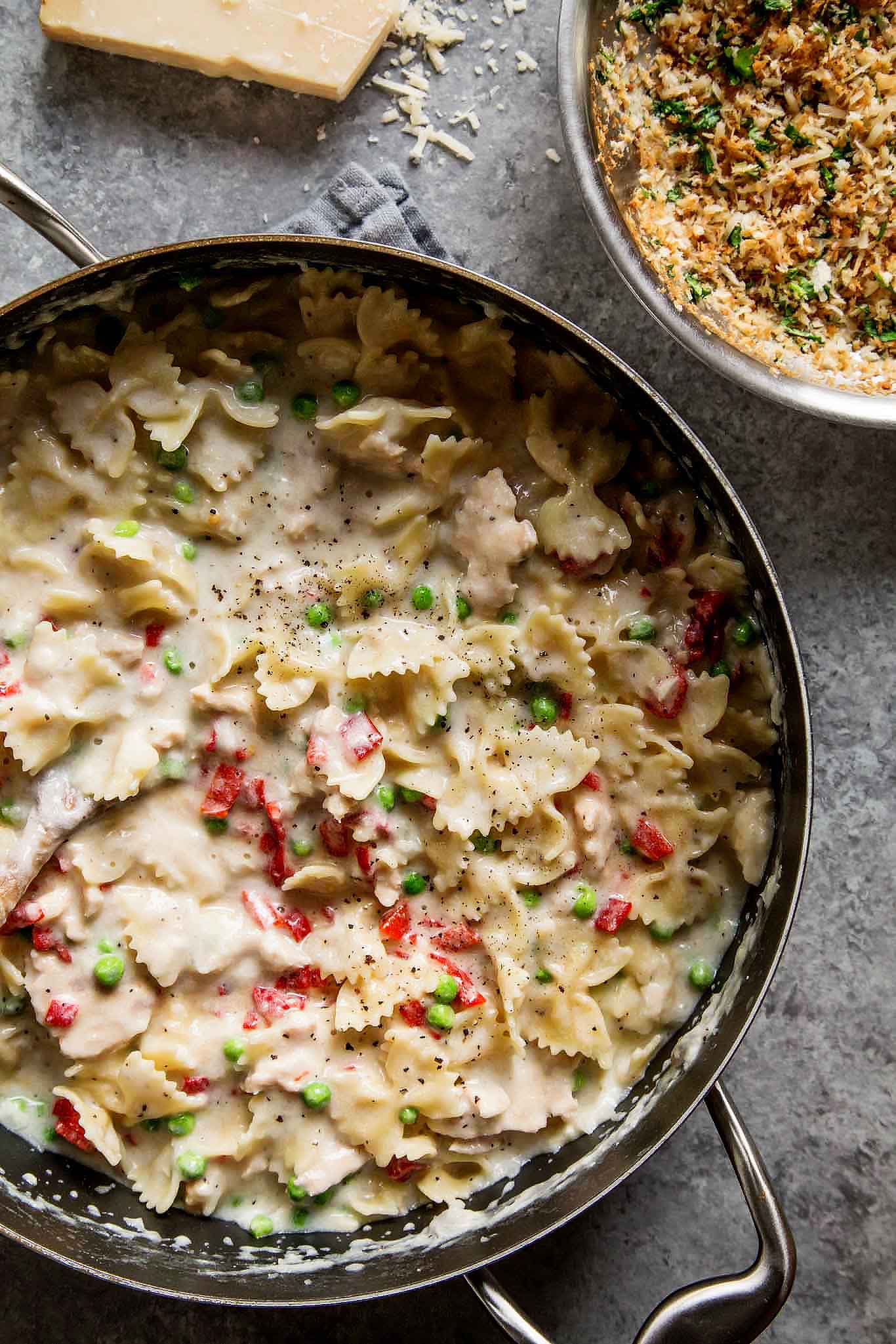 Tuna Noodle Casserole with Piquillo Peppers and Gruyere Cheese is an upgraded version of the classic tuna noodle casserole. Spiked with a bit of white wine and topped with buttery parmesan breadcrumbs – Yum! | platingsandpairings.com