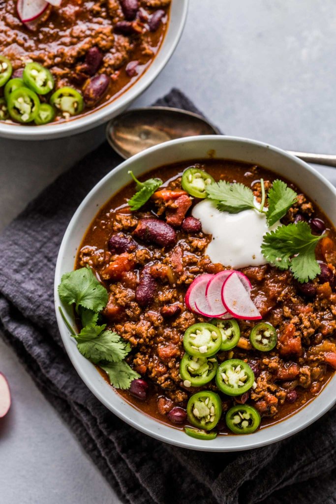 Two bowls of beer chili on counter. 