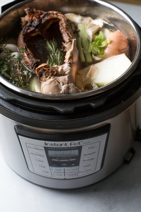 Side view of ingredients for broth in instant pot. 