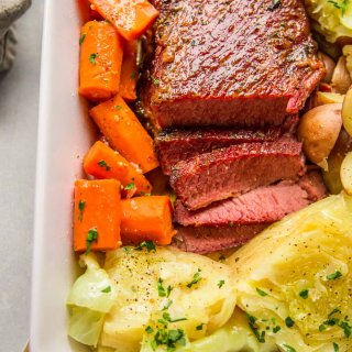 Instant Pot Corned Beef & Cabbage in a baking dish with carrots and potatoes