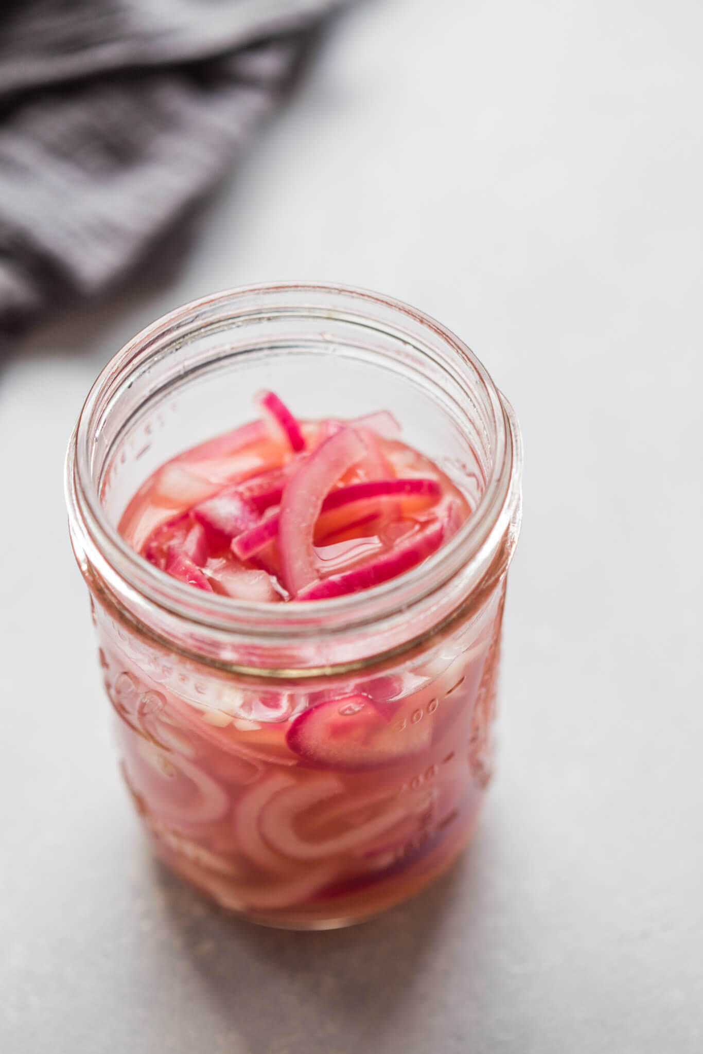Side view jar of quick pickled onions.