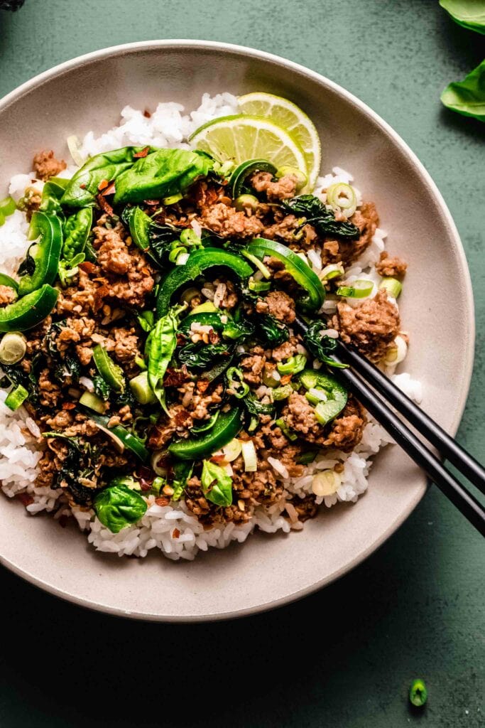 Overhead close up of Thai basil beef in serving bowl. 