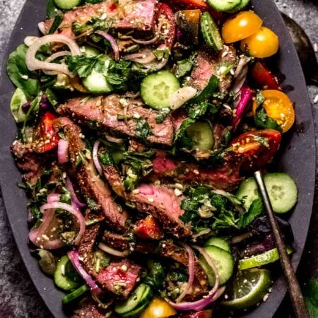 Thai beef salad arranged on serving platter.