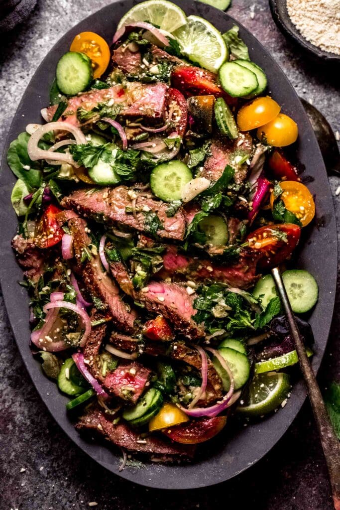 Thai beef salad arranged on serving platter.