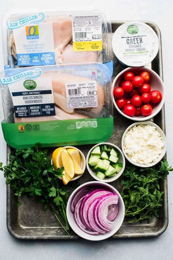 Ingredients for chicken gyro bowls on tray. 