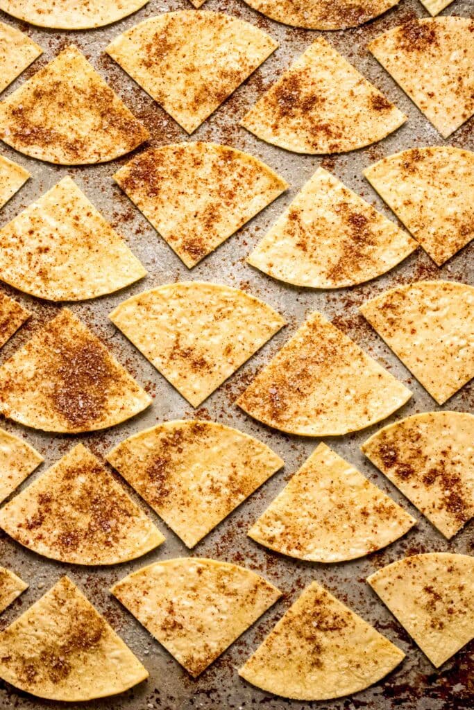 Sliced tortillas on baking sheet before baking.