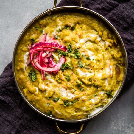 Overhead closeup view of split pea dal with pickled red onions