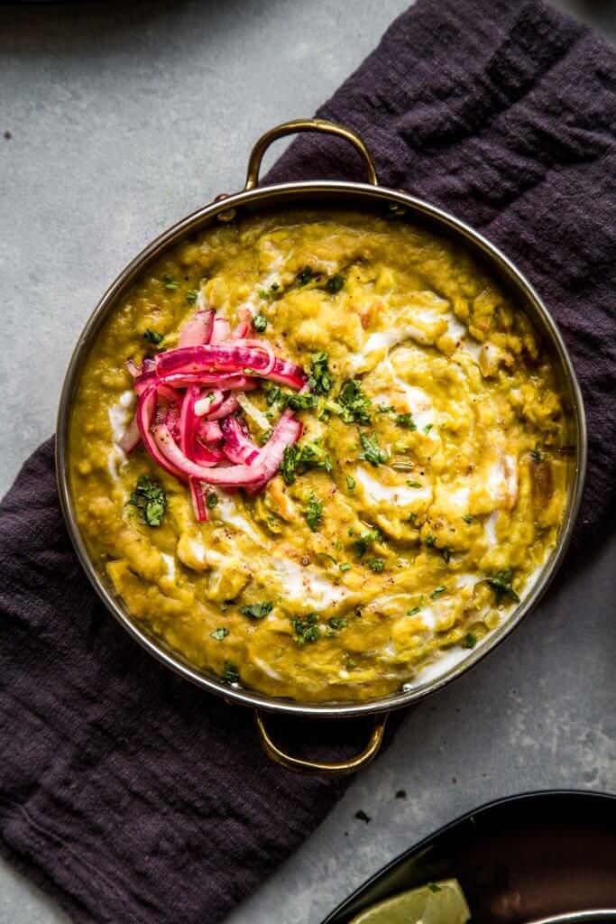 Overhead closeup view of split pea dal with pickled red onions