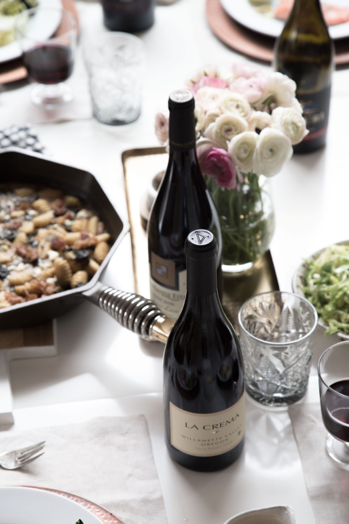 Two bottles of Oregon Pinot Noir on dinner table with place settings. Ready to eat!