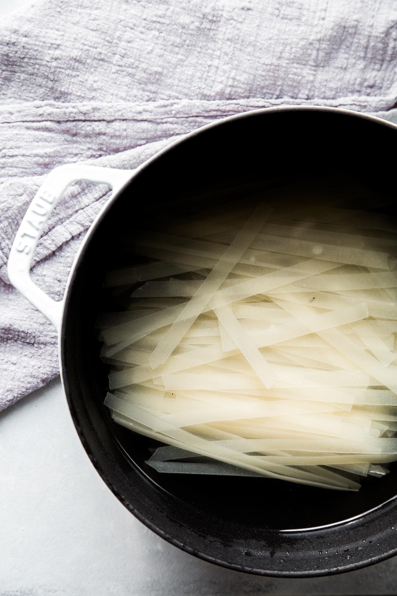 rice noodles soaking for pad kee mao