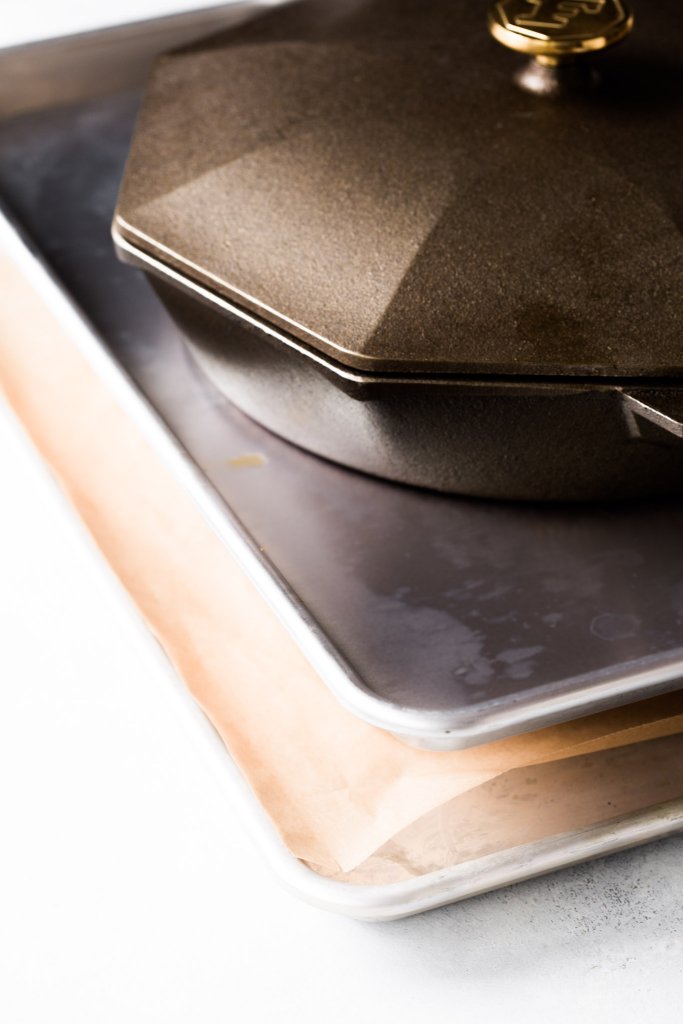Iron skillet on top of baking sheet. 