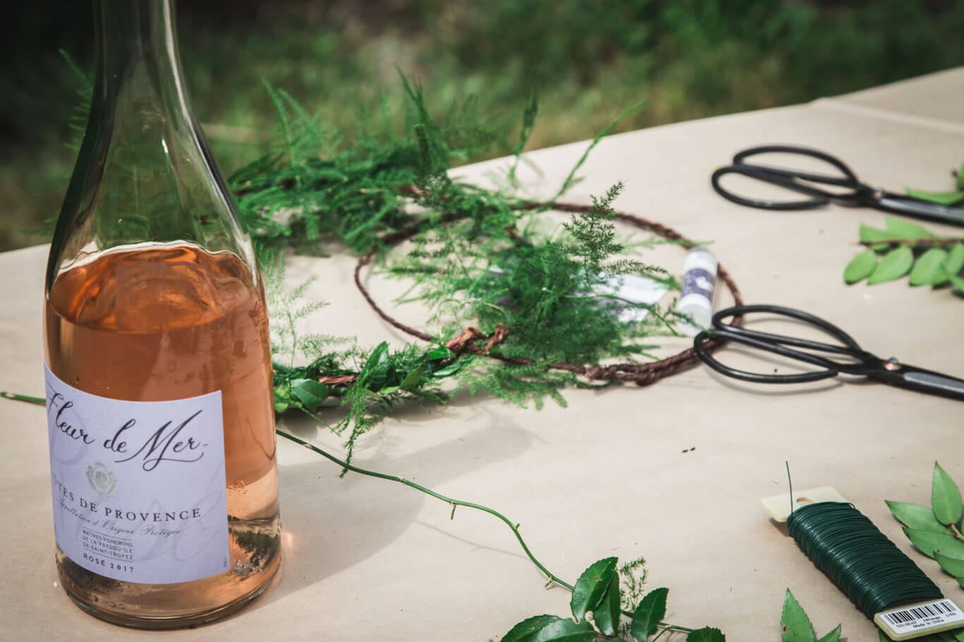 Flower crown creating station next to rosé
