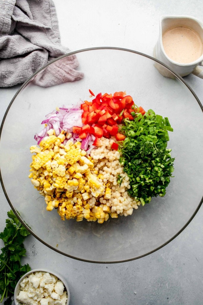 Ingredients for street corn salad in bowl before tossing together. 