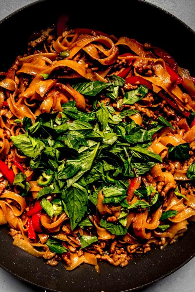 Kee mao in pan with fresh basil. 