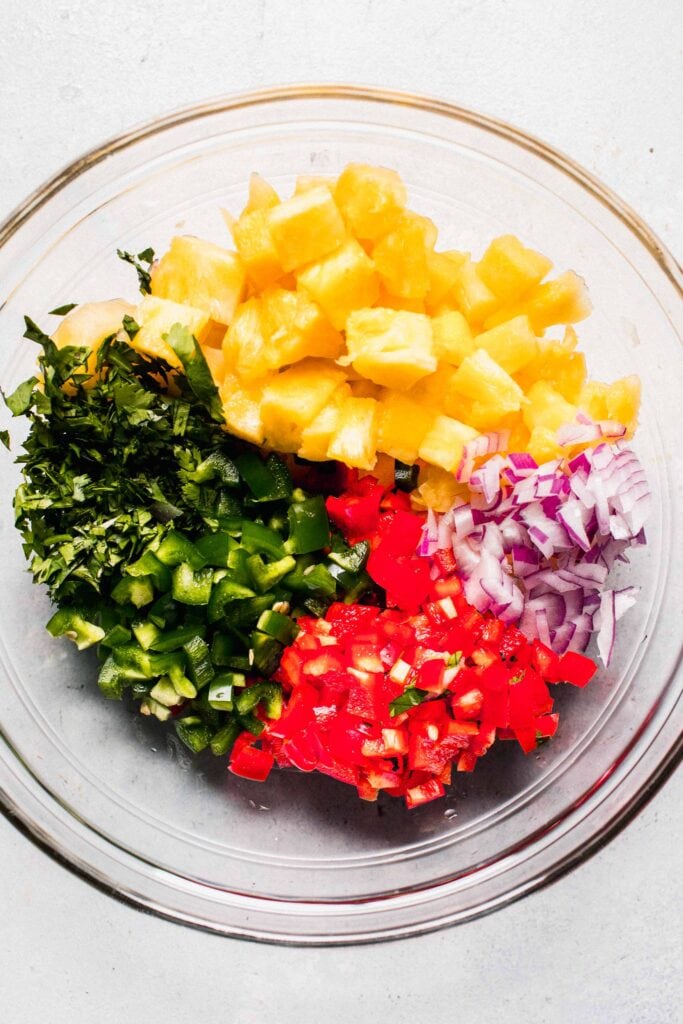 Ingredients for pineapple salsa in bowl. 