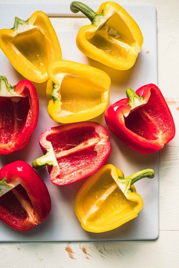 Sliced pepper halves on cutting board. 