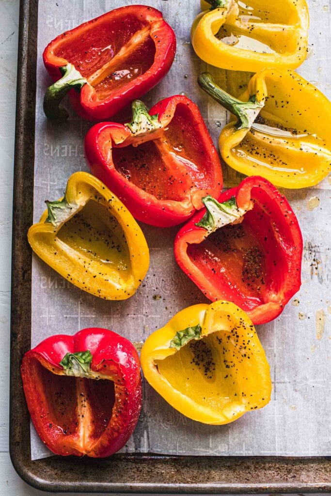 Baked pepper halves on baking sheet. 