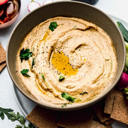 OVERHEAD SHOT OF BOWL OF BABA GANOUSH SWIRLED WITH OLIVE OIL.