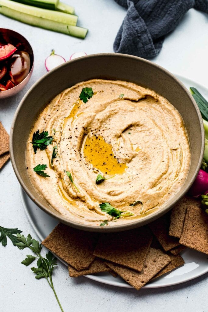 OVERHEAD SHOT OF BOWL OF BABA GANOUSH SWIRLED WITH OLIVE OIL.